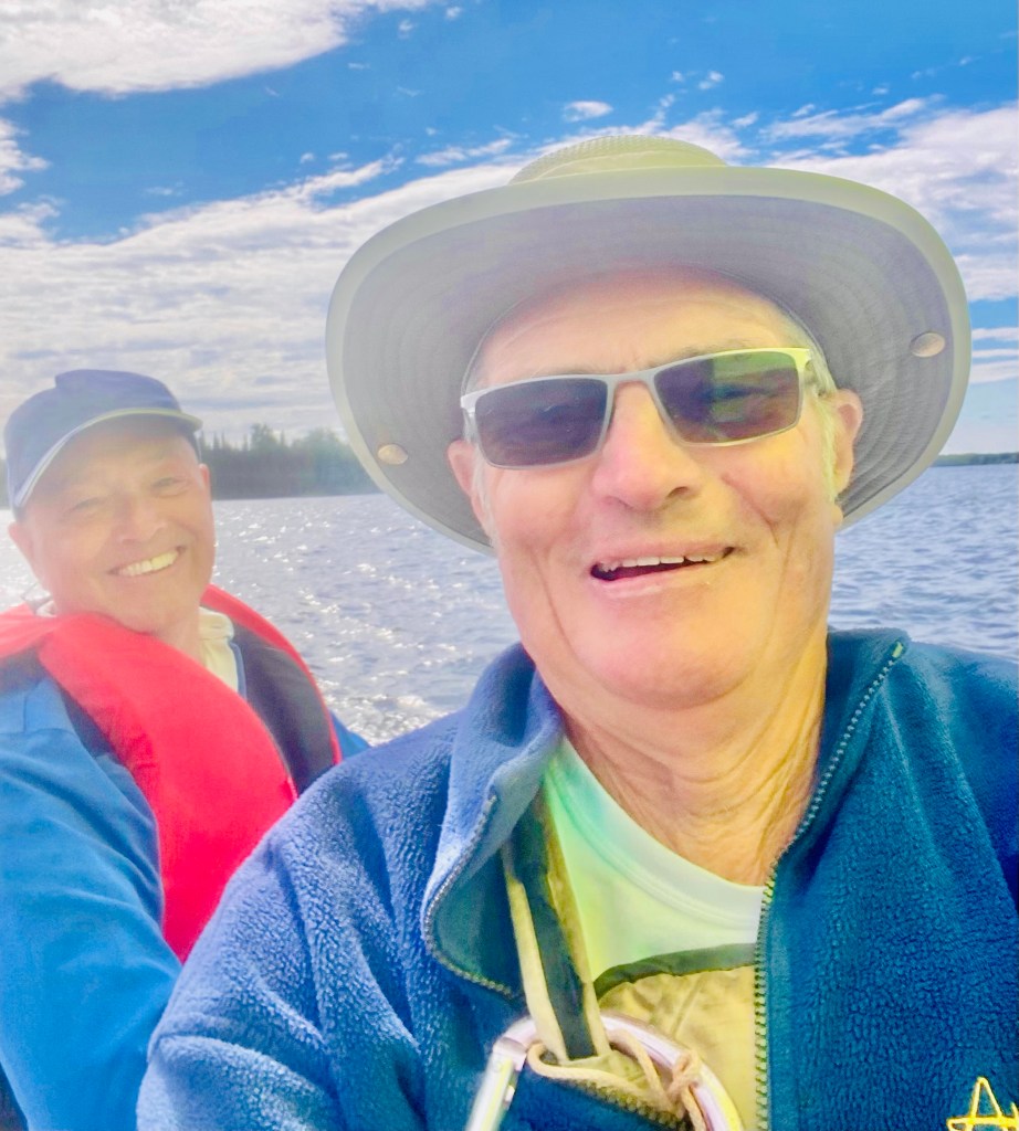 Two men smiling while sailing