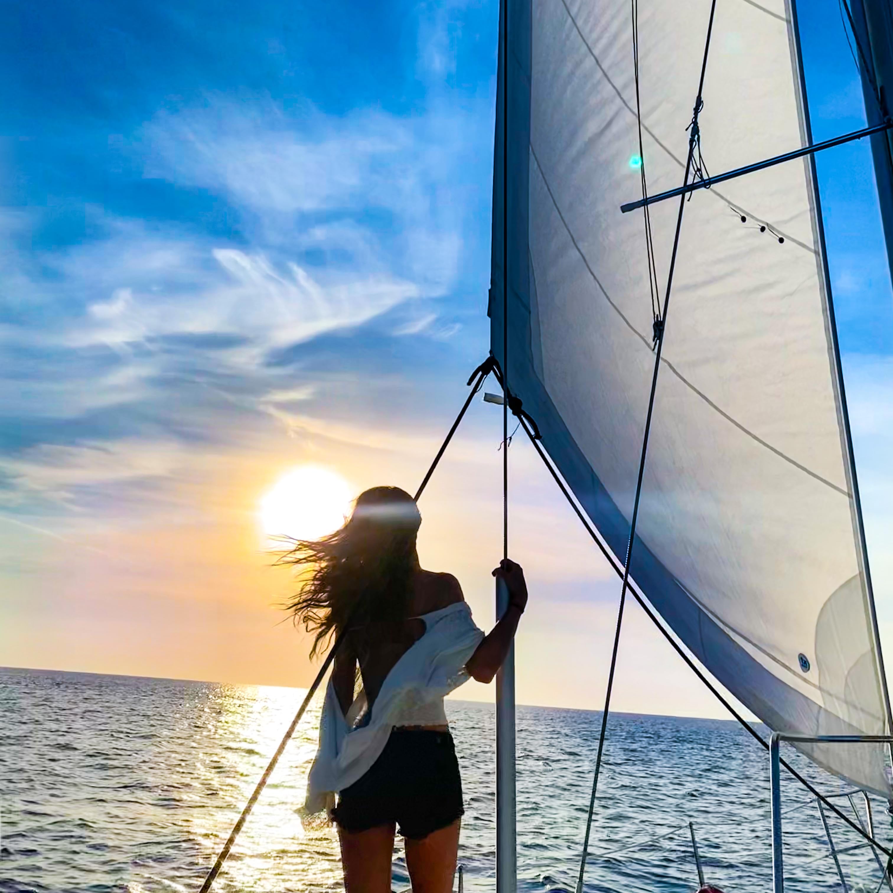 Lauren Landers on a sailboat sailing into the sunset